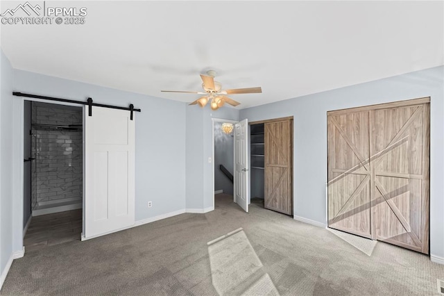 5360 Tupper Ct, Colorado Springs, CO 80923 - unfurnished bedroom featuring a barn door, carpet floors, a ceiling fan, and a closet