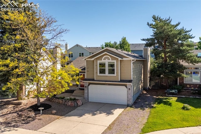 5360 Tupper Ct, Colorado Springs, CO 80923 - view of front facade with a chimney, a garage, driveway, and brick siding