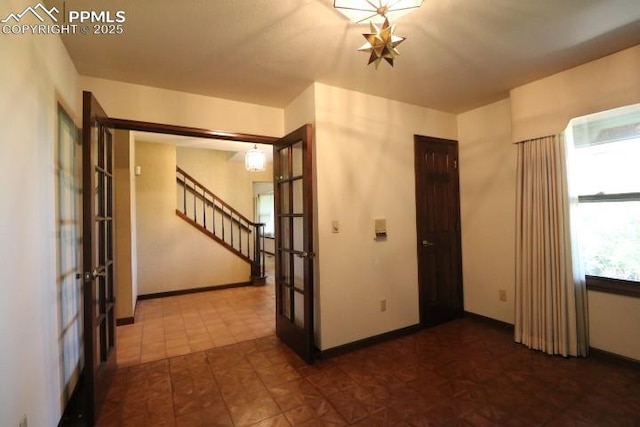 4170 Broadmoor Bluffs Dr, Colorado Springs, CO 80906 - empty room with french doors and stairway