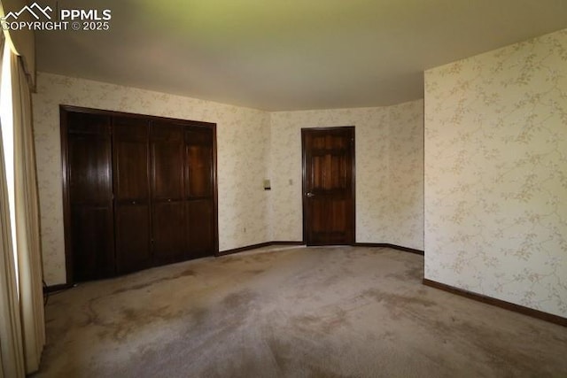 4170 Broadmoor Bluffs Dr, Colorado Springs, CO 80906 - unfurnished bedroom with carpet floors, wallpapered walls, and a closet