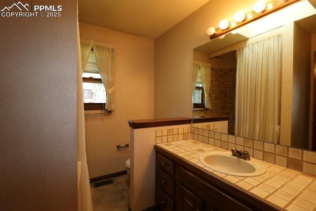4170 Broadmoor Bluffs Dr, Colorado Springs, CO 80906 - full bath with plenty of natural light, tasteful backsplash, vanity, and a shower with shower curtain