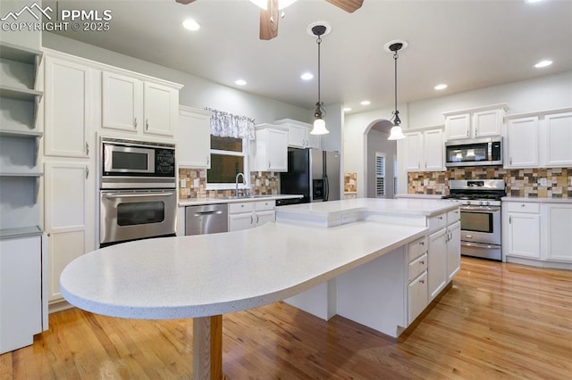 10489 Cedar Breaks Dr, Peyton, CO 80831 - kitchen featuring appliances with stainless steel finishes, a ceiling fan, a center island, white cabinetry, and recessed lighting