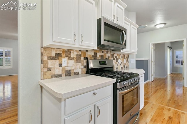 10489 Cedar Breaks Dr, Peyton, CO 80831 - kitchen featuring appliances with stainless steel finishes, decorative backsplash, light wood finished floors, and light countertops