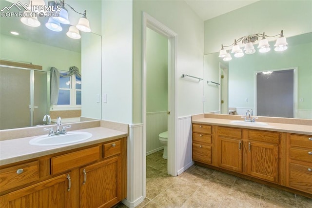 10489 Cedar Breaks Dr, Peyton, CO 80831 - full bathroom with vanity, a shower stall, wainscoting, tile patterned flooring, and a chandelier