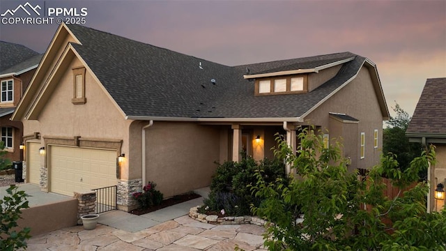 10489 Cedar Breaks Dr, Peyton, CO 80831 - view of front of property with driveway, an attached garage, stucco siding, and roof with shingles