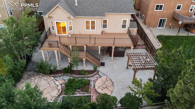 10489 Cedar Breaks Dr, Peyton, CO 80831 - back of property with stairs, a shingled roof, a patio, stucco siding, and a deck