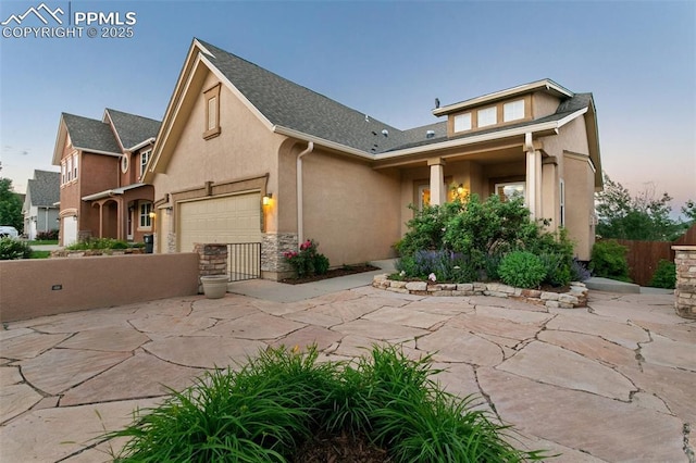 10489 Cedar Breaks Dr, Peyton, CO 80831 - view of front of house with stucco siding, driveway, a garage, and a shingled roof