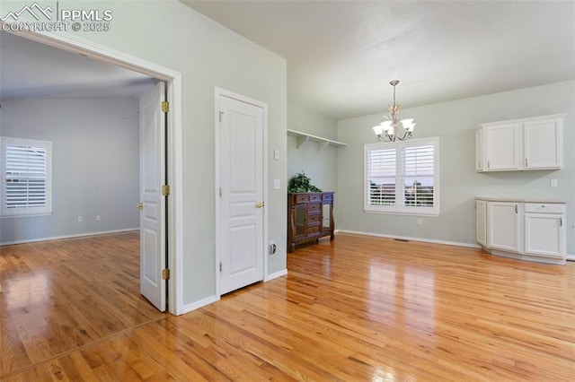 10489 Cedar Breaks Dr, Peyton, CO 80831 - unfurnished dining area with a chandelier and light wood finished floors