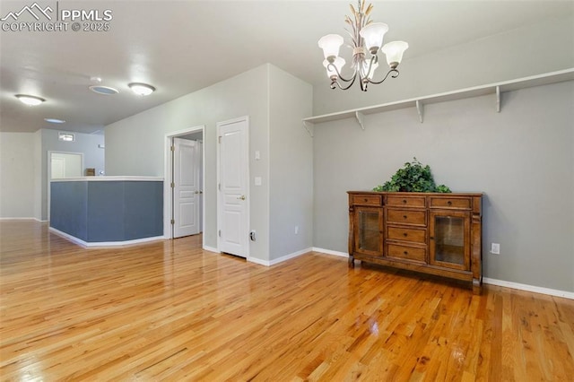 10489 Cedar Breaks Dr, Peyton, CO 80831 - spare room with wood finished floors and a chandelier