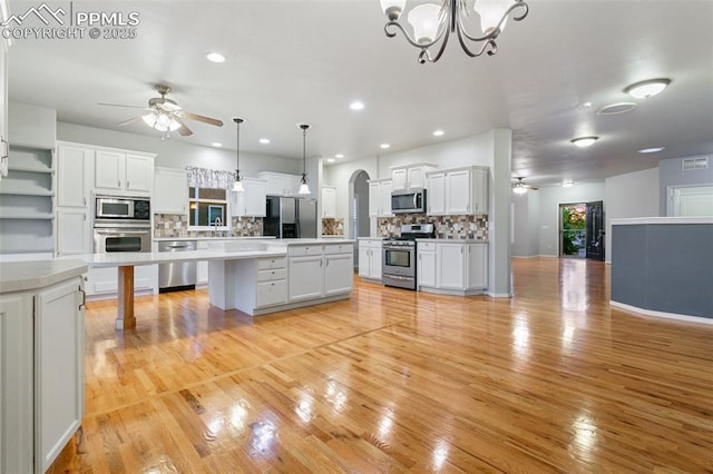 10489 Cedar Breaks Dr, Peyton, CO 80831 - kitchen featuring stainless steel appliances, a ceiling fan, backsplash, a chandelier, and recessed lighting