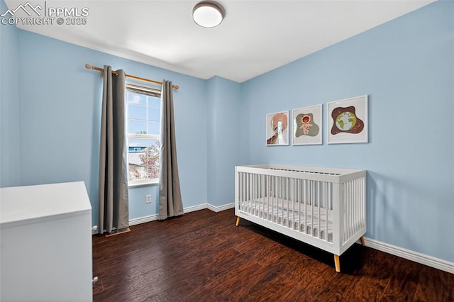 3035 Cascade Falls Pt, Colorado Springs, CO 80922 - bedroom featuring wood finished floors and a nursery area