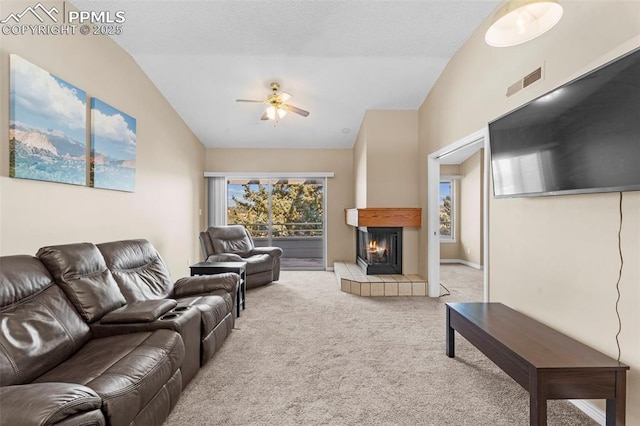 3692 Iguana Dr, Colorado Springs, CO 80910 - carpeted living room featuring lofted ceiling, ceiling fan, and a glass covered fireplace