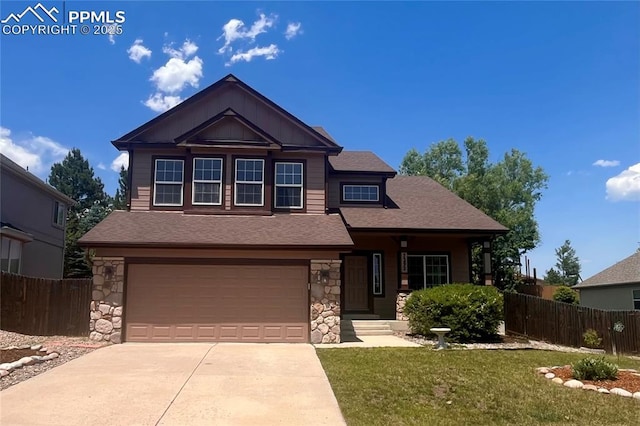 7292 Gardenstone Dr, Colorado Springs, CO 80922 - craftsman inspired home with stone siding, concrete driveway, a garage, and a shingled roof