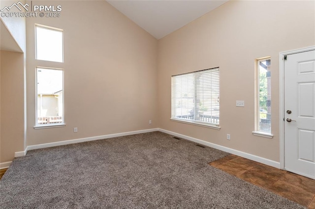7292 Gardenstone Dr, Colorado Springs, CO 80922 - foyer with dark colored carpet and high vaulted ceiling