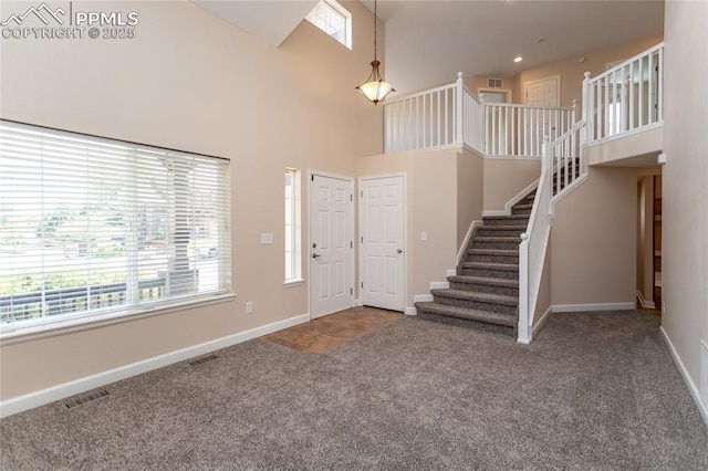 7292 Gardenstone Dr, Colorado Springs, CO 80922 - carpeted entrance foyer with a high ceiling and stairs