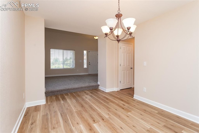 7292 Gardenstone Dr, Colorado Springs, CO 80922 - empty room featuring a chandelier and light wood-type flooring