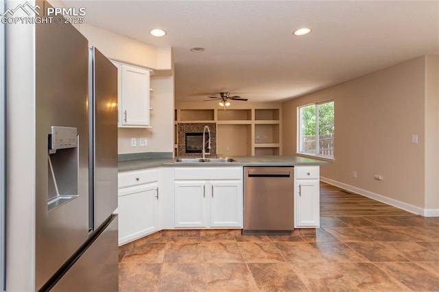 7292 Gardenstone Dr, Colorado Springs, CO 80922 - kitchen featuring stainless steel appliances, a peninsula, a ceiling fan, white cabinetry, and open shelves