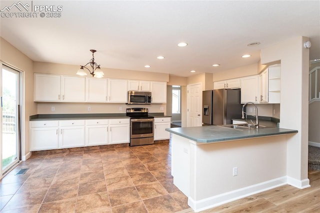 7292 Gardenstone Dr, Colorado Springs, CO 80922 - kitchen with appliances with stainless steel finishes, open shelves, plenty of natural light, white cabinets, and recessed lighting