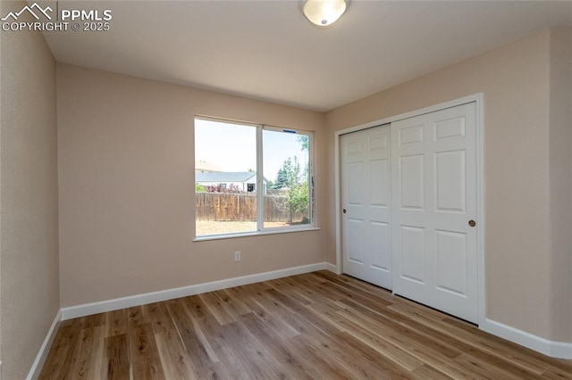 7292 Gardenstone Dr, Colorado Springs, CO 80922 - unfurnished bedroom with light wood-style flooring and a closet