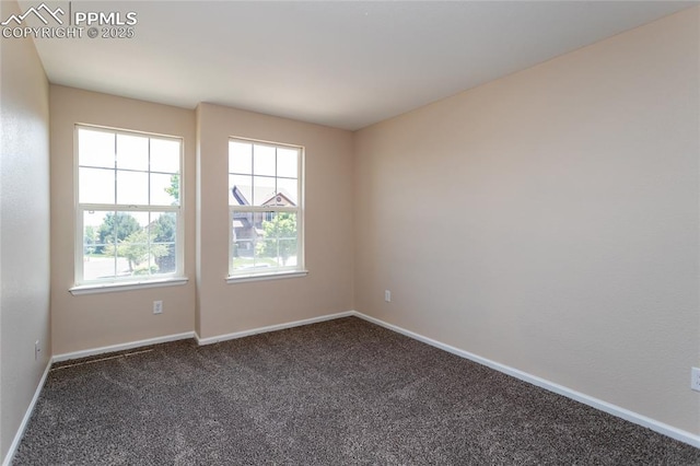 7292 Gardenstone Dr, Colorado Springs, CO 80922 - empty room featuring dark colored carpet and baseboards