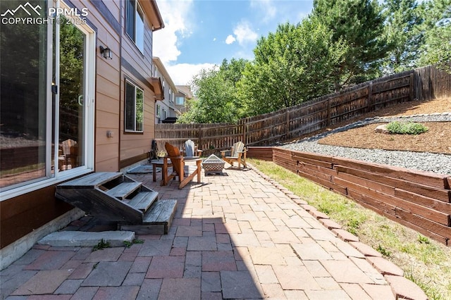 7292 Gardenstone Dr, Colorado Springs, CO 80922 - fenced backyard with a patio area and an outdoor fire pit