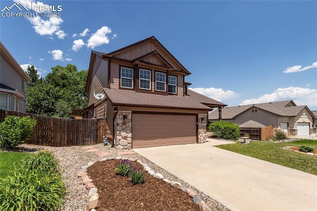 7292 Gardenstone Dr, Colorado Springs, CO 80922 - view of front of house featuring stone siding, an attached garage, driveway, and board and batten siding
