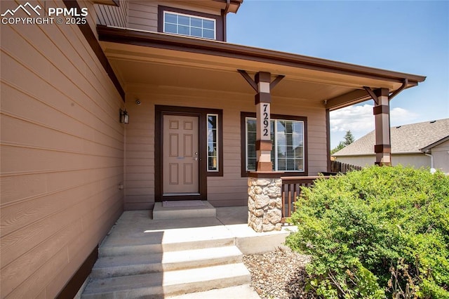 7292 Gardenstone Dr, Colorado Springs, CO 80922 - property entrance featuring covered porch and stone siding