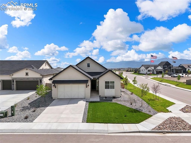 8309 Tom Ketchum Dr, Colorado Springs, CO 80908 - view of front of property featuring an attached garage, driveway, stucco siding, a front yard, and a residential view