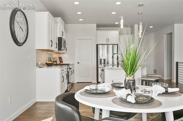 8309 Tom Ketchum Dr, Colorado Springs, CO 80908 - dining space with recessed lighting and dark wood-type flooring