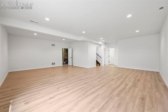 8309 Tom Ketchum Dr, Colorado Springs, CO 80908 - unfurnished living room with recessed lighting, light wood-style floors, and stairway
