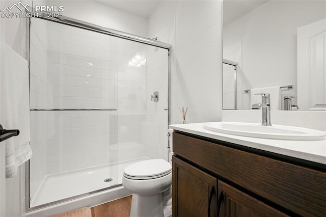 8309 Tom Ketchum Dr, Colorado Springs, CO 80908 - full bathroom featuring a stall shower, vanity, and wood finished floors