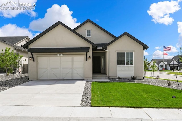 8309 Tom Ketchum Dr, Colorado Springs, CO 80908 - view of front facade with stucco siding, a garage, driveway, and a front yard