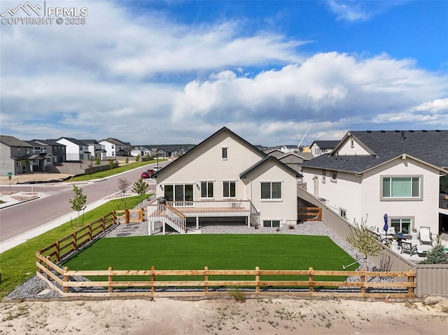 8309 Tom Ketchum Dr, Colorado Springs, CO 80908 - back of house featuring a fenced backyard, stairway, a residential view, a wooden deck, and stucco siding
