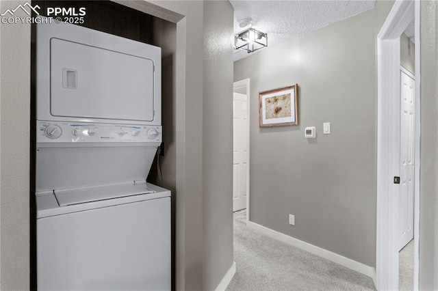 4742 Villa Cir Unit A, Colorado Springs, CO 80918 - washroom with stacked washer and clothes dryer, carpet flooring, and a textured ceiling