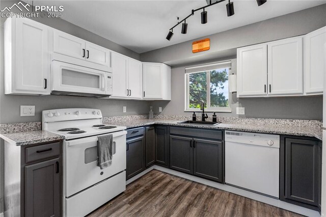 4742 Villa Cir Unit A, Colorado Springs, CO 80918 - kitchen featuring white appliances, white cabinets, track lighting, and dark wood-style flooring