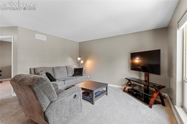4742 Villa Cir Unit A, Colorado Springs, CO 80918 - carpeted living area with baseboards and a textured ceiling