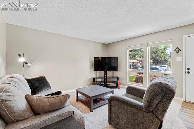 4742 Villa Cir Unit A, Colorado Springs, CO 80918 - living area featuring a textured ceiling and baseboards