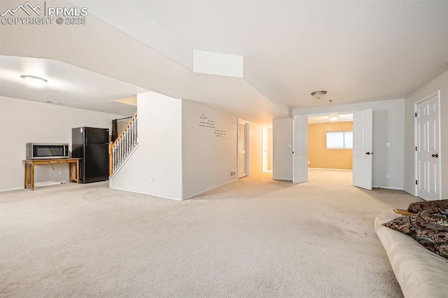 5480 Flag Way, Colorado Springs, CO 80919 - unfurnished living room featuring light carpet and stairway