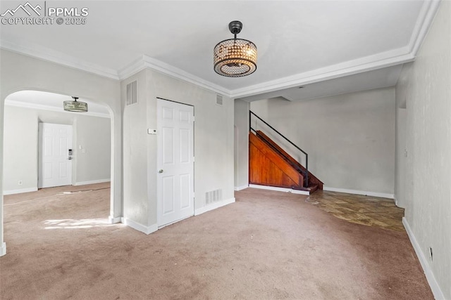 109 S 24th St, Colorado Springs, CO 80904 - unfurnished living room featuring carpet flooring, arched walkways, stairway, a chandelier, and crown molding