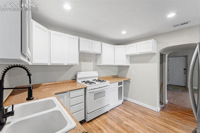 109 S 24th St, Colorado Springs, CO 80904 - kitchen with gas range gas stove, white cabinets, light wood-style floors, and recessed lighting
