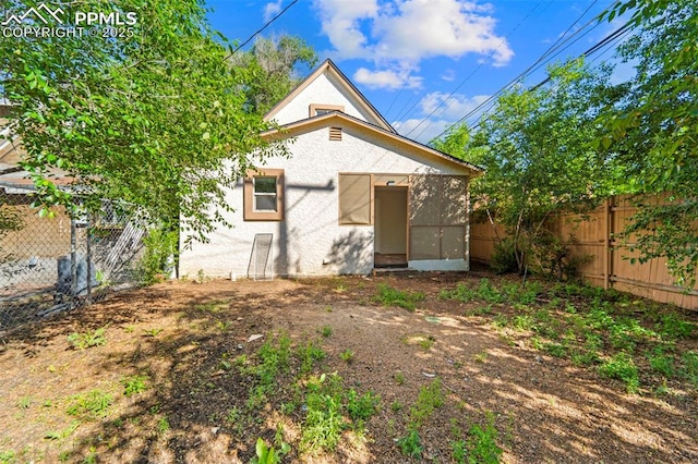 109 S 24th St, Colorado Springs, CO 80904 - rear view of house with a fenced backyard and stucco siding
