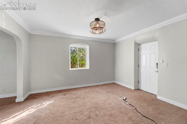 109 S 24th St, Colorado Springs, CO 80904 - empty room featuring arched walkways, crown molding, carpet flooring, and a chandelier
