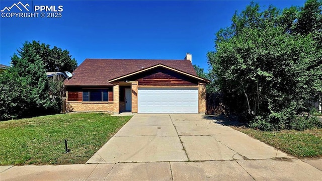 3095 Post Oak Dr, Colorado Springs, CO 80916 - view of front of property featuring an attached garage, a front lawn, concrete driveway, and brick siding