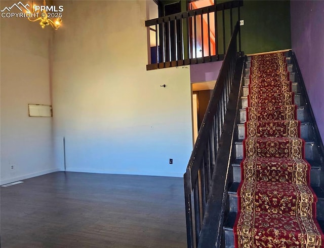 3095 Post Oak Dr, Colorado Springs, CO 80916 - stairway featuring wood finished floors, a towering ceiling, and a chandelier