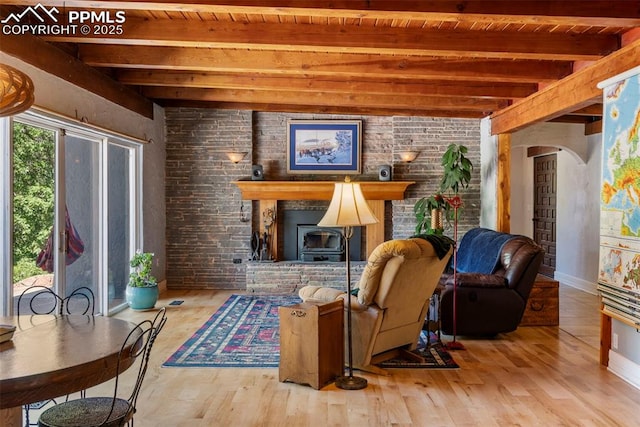 4440 Heizer St, Cascade, CO 80809 - living area with a wooden ceiling with exposed beams, wood finished floors, arched walkways, and a wood stove