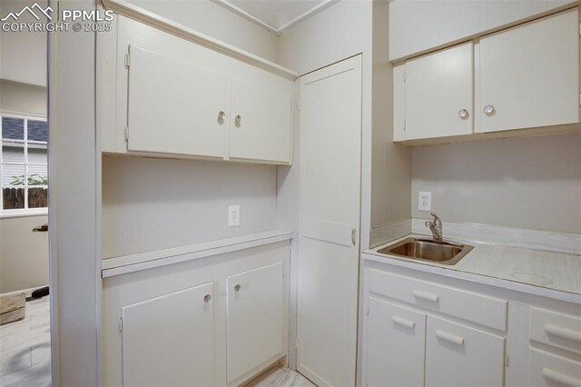 122 E Jefferson St, Colorado Springs, CO 80907 - kitchen featuring light countertops and white cabinetry