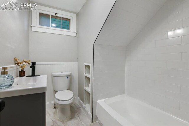 122 E Jefferson St, Colorado Springs, CO 80907 - bathroom featuring vanity, a wainscoted wall, marble finish flooring, and lofted ceiling