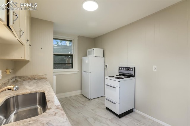 122 E Jefferson St, Colorado Springs, CO 80907 - kitchen with white appliances, light marble finish flooring, and light stone counters