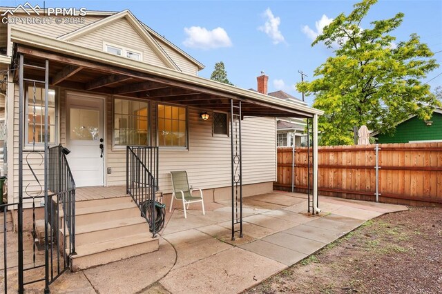 122 E Jefferson St, Colorado Springs, CO 80907 - rear view of house with a patio and a chimney