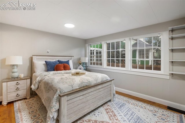 122 E Jefferson St, Colorado Springs, CO 80907 - bedroom with wood finished floors and multiple windows